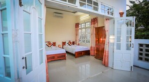 A room with two beds, a wooden wardrobe, and a large window with curtains. - Rice Village Homestay (Da Nang)
