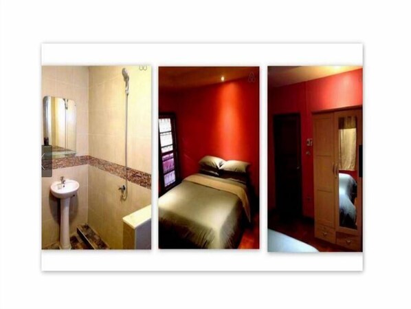 Un baño con lavamanos y ducha, una cama con pared roja y ventana, y un armario de madera.