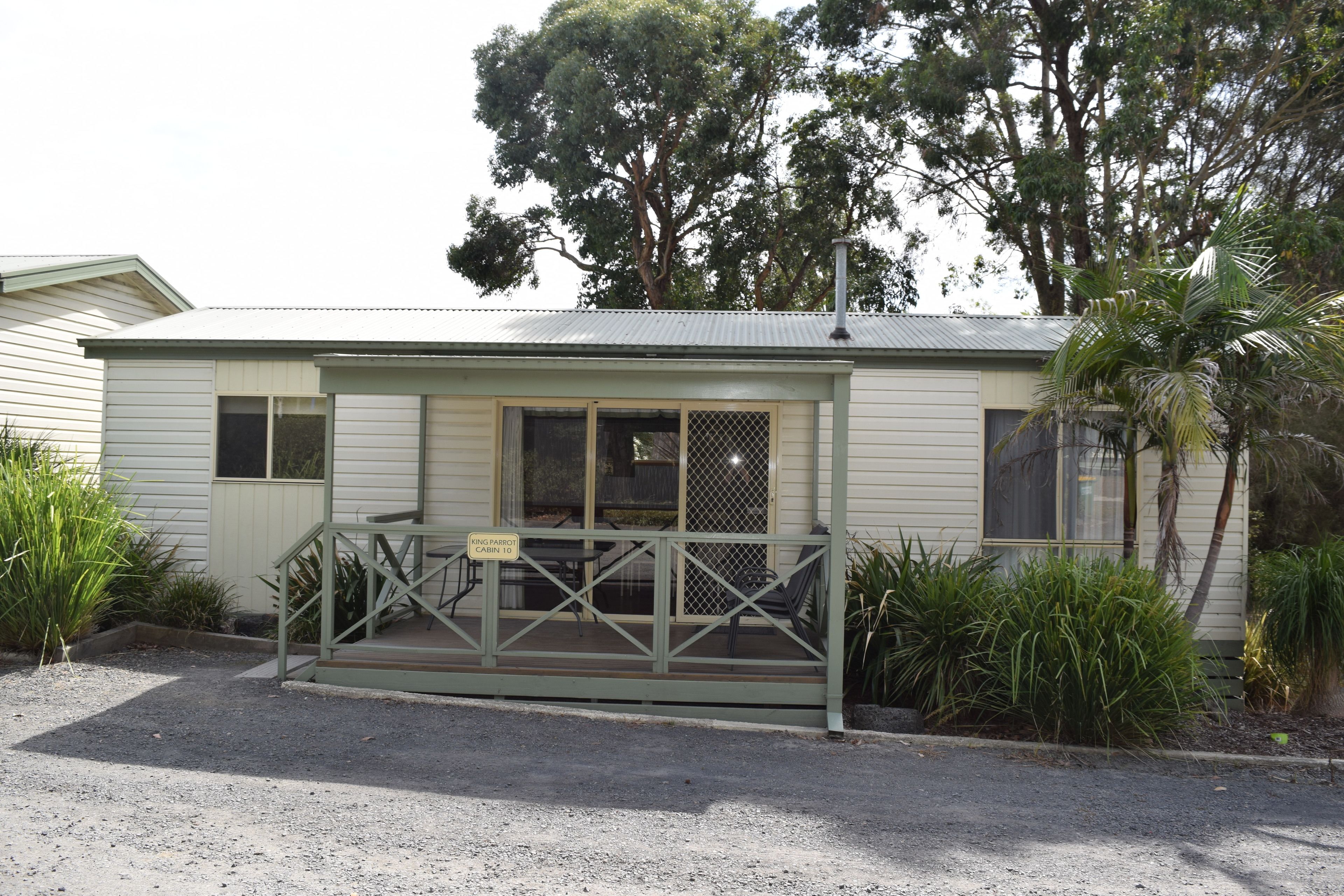 A small, single-story building with a porch and a sign indicating a 'Ring Pabbot Cabin to'.