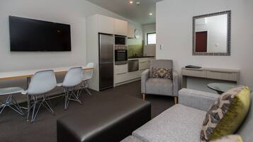 Premium Suite, 2 Bedrooms | Living area | 52-inch flat-screen TV with cable channels, TV