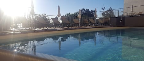 Outdoor pool, an infinity pool, open 9:30 AM to 7:30 PM, pool umbrellas