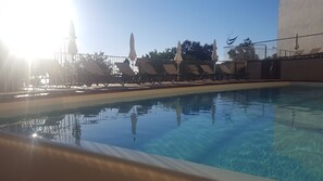 Outdoor pool, an infinity pool, open 9:30 AM to 7:30 PM, pool umbrellas