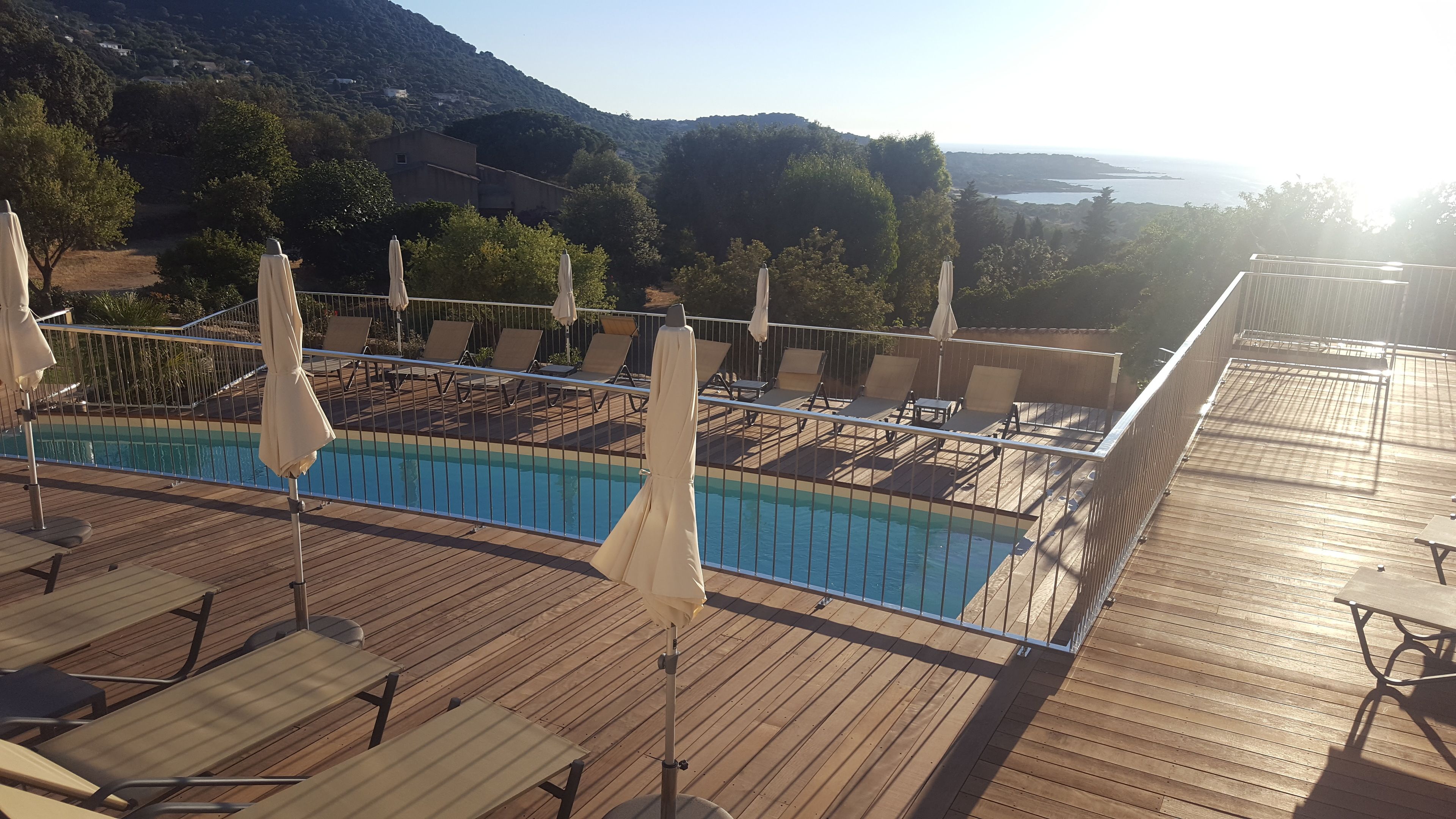 seasonal outdoor pool, an infinity pool, pool umbrellas, pool loungers