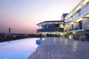 A modern building with a curved roof and a wooden deck. - Grandia Hotel (Bandung)