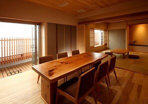A traditional Japanese-style room with tatami flooring, a wooden dining table, and sliding doors. - Matsumotoro (Shibukawa)