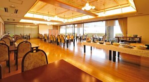 A spacious dining area with long tables and chairs, large windows, and a high ceiling with skylights. - Matsumotoro (Shibukawa)