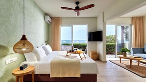 A spacious bedroom with a large bed, a ceiling fan, a TV, and a balcony with a view of the sea. - Vasia Sea Retreat - Adults Only. (Agios Nikolaos)