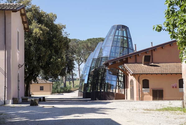 A building with a modern glass structure and traditional architecture. - I Casali del Pino (Rome)