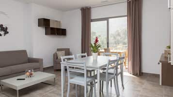 Premium Apartment, 2 Bedrooms, Terrace | Living room | 100-cm flat-screen TV with satellite channels, TV