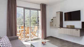 Premium Apartment, 1 Bedroom, Terrace | Living area | 100-cm flat-screen TV with satellite channels, TV