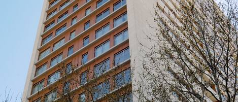 A tall building with multiple floors and numerous windows.