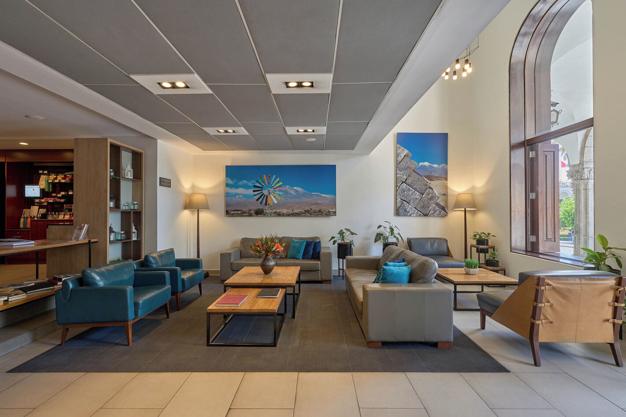 A modern lobby with leather sofas, a coffee table, and a reception desk.