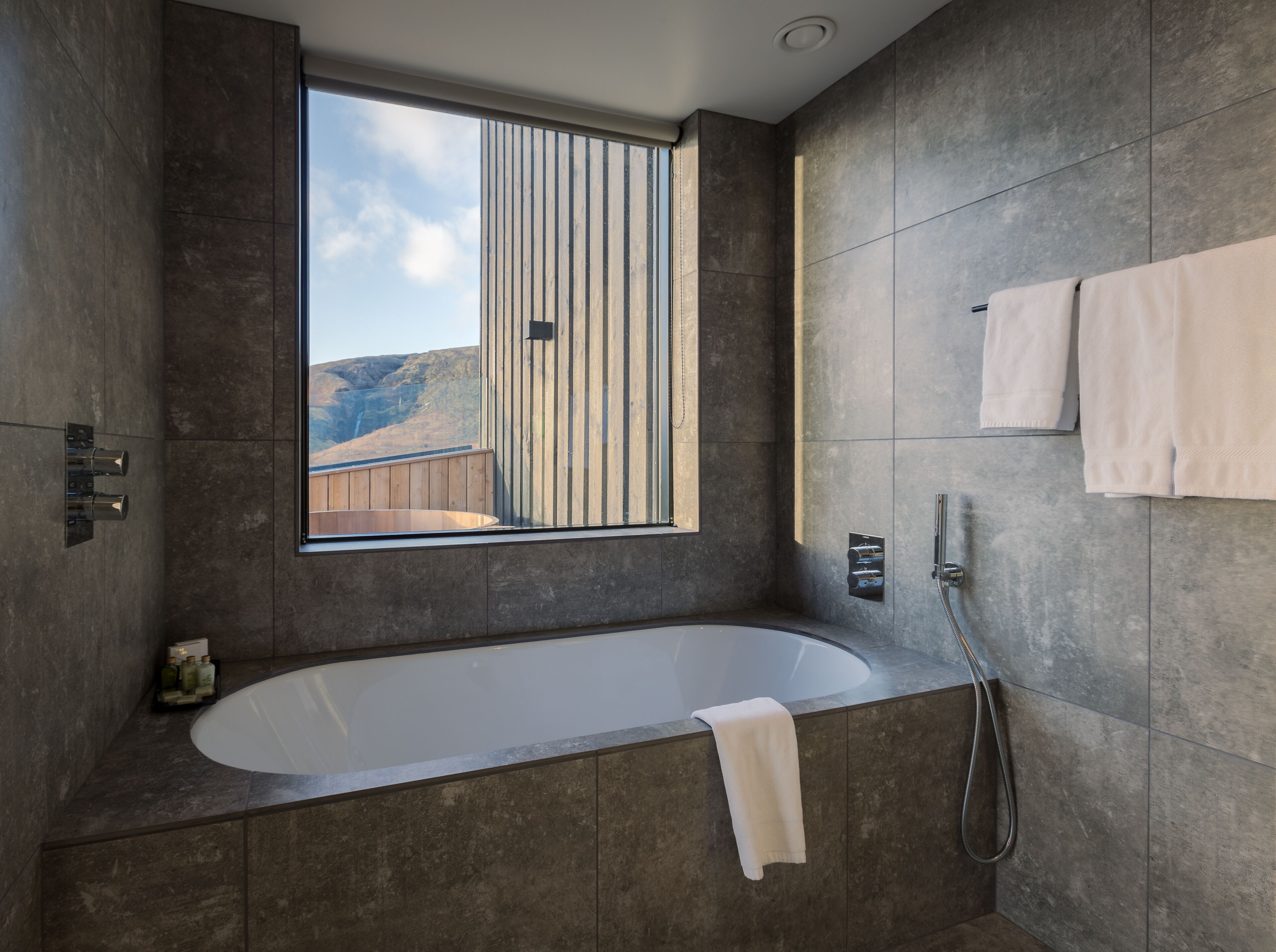 executive suite | bathroom | shower, hair dryer, slippers, heated floors
