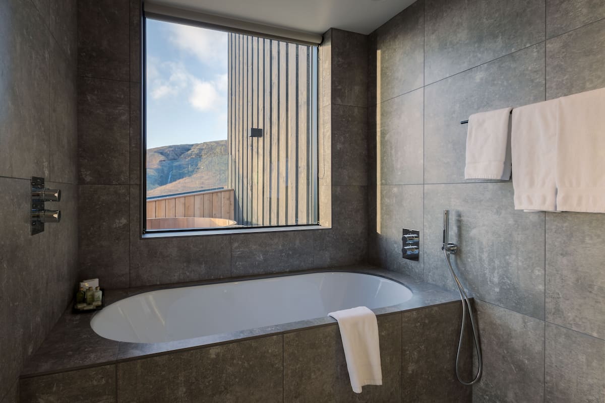 executive suite | bathroom | shower, hair dryer, slippers, heated floors