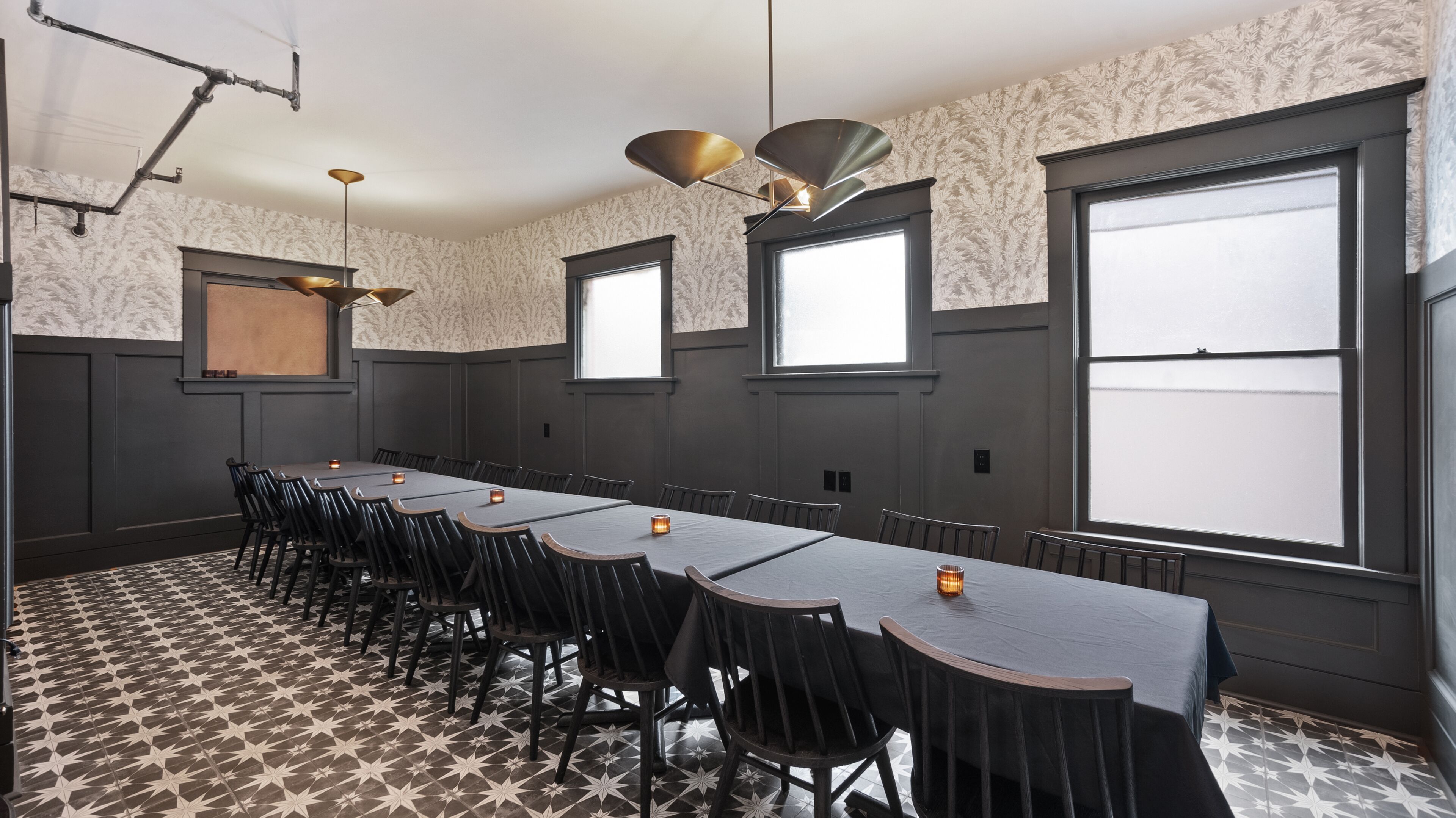 A conference room with a long table, chairs, and large windows.