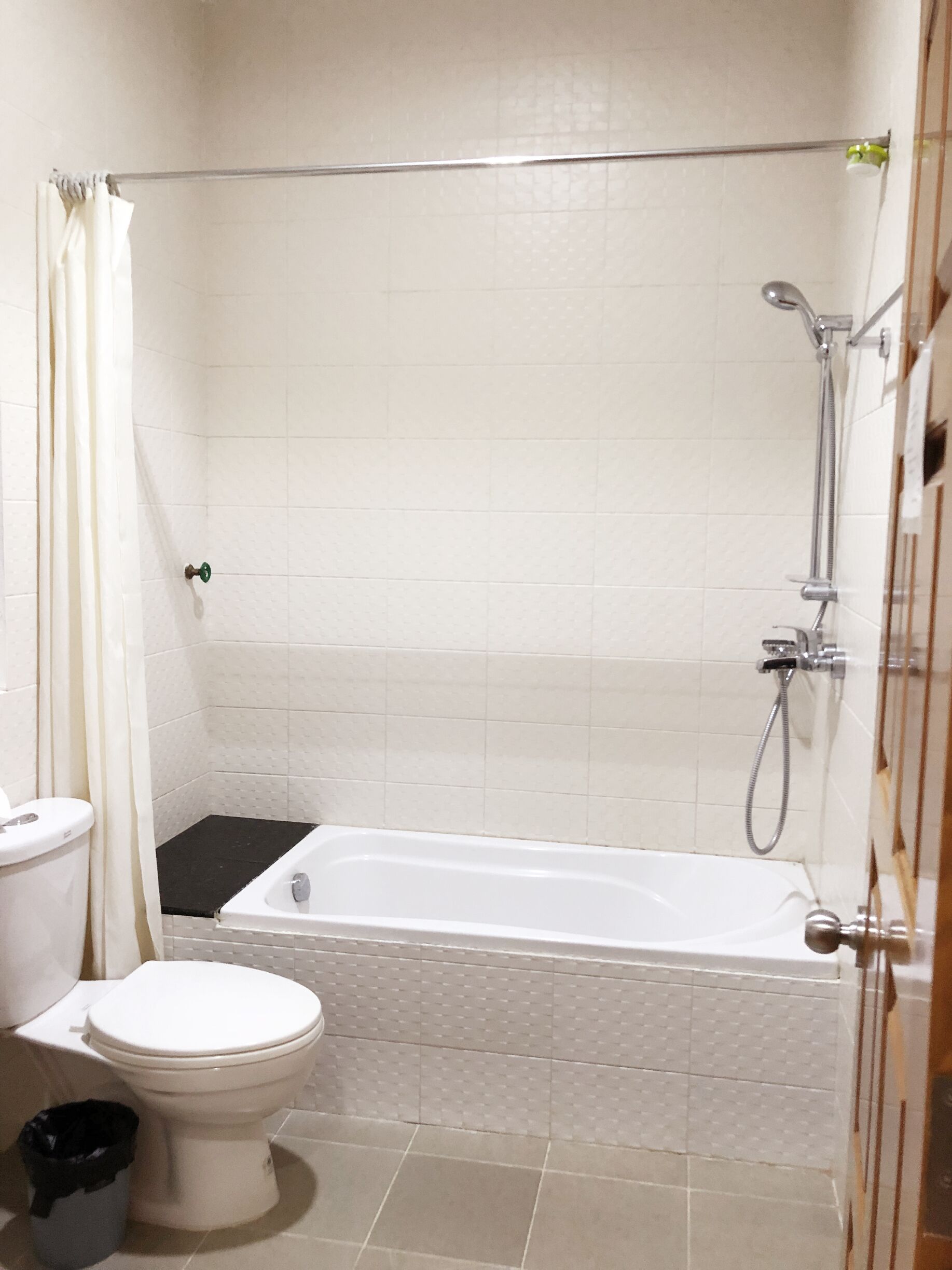 A bathroom with a bathtub, toilet, and shower.