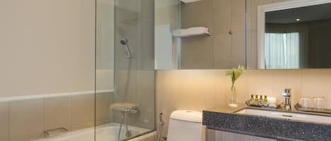 A modern bathroom with a glass-enclosed shower, a toilet, and a vanity with a mirror.