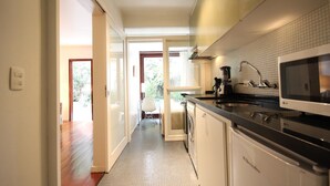 A modern kitchen with a microwave, stove, and sink. - Gomide SP 21 (São Paulo)
