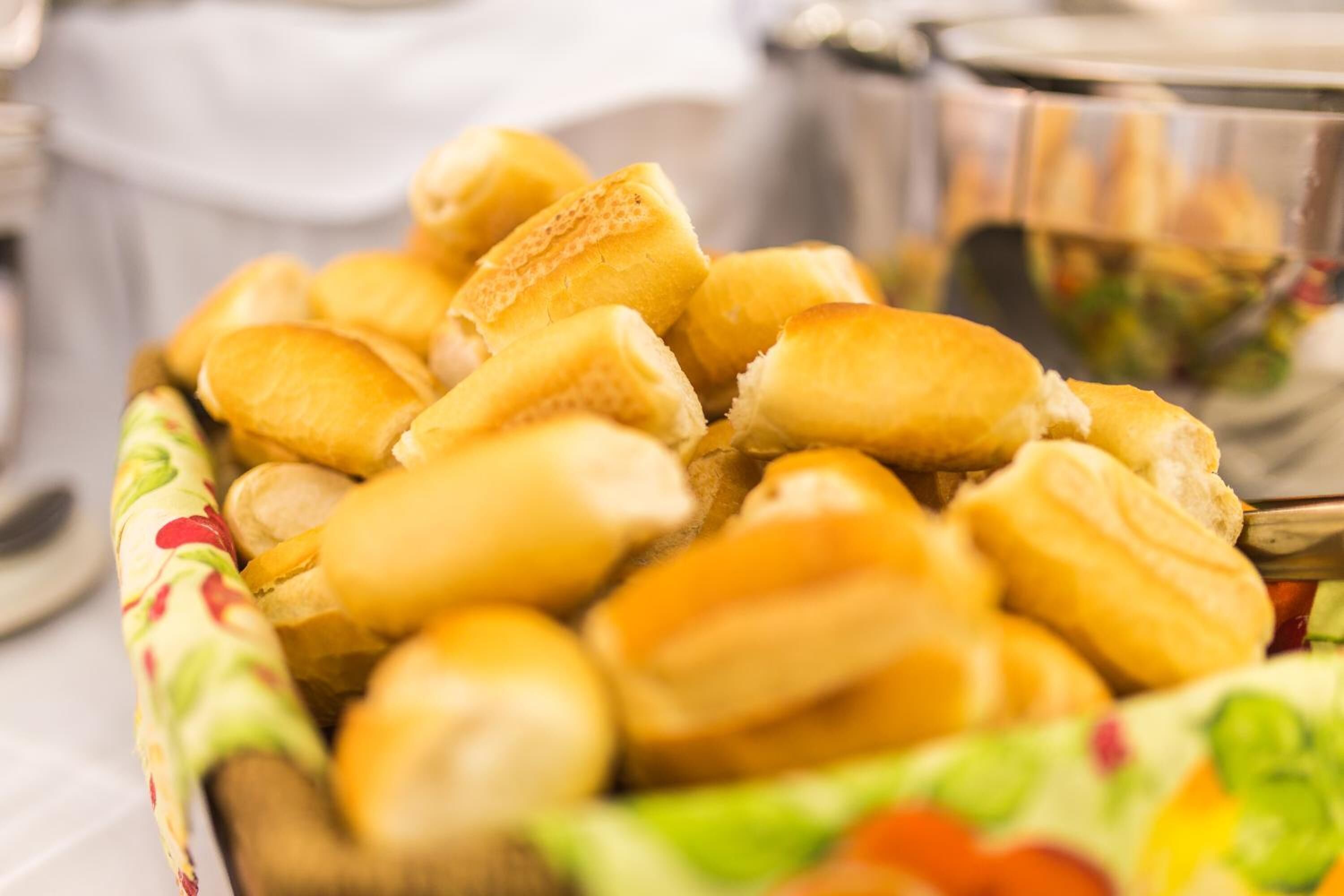 A basket of bread rolls on a table.