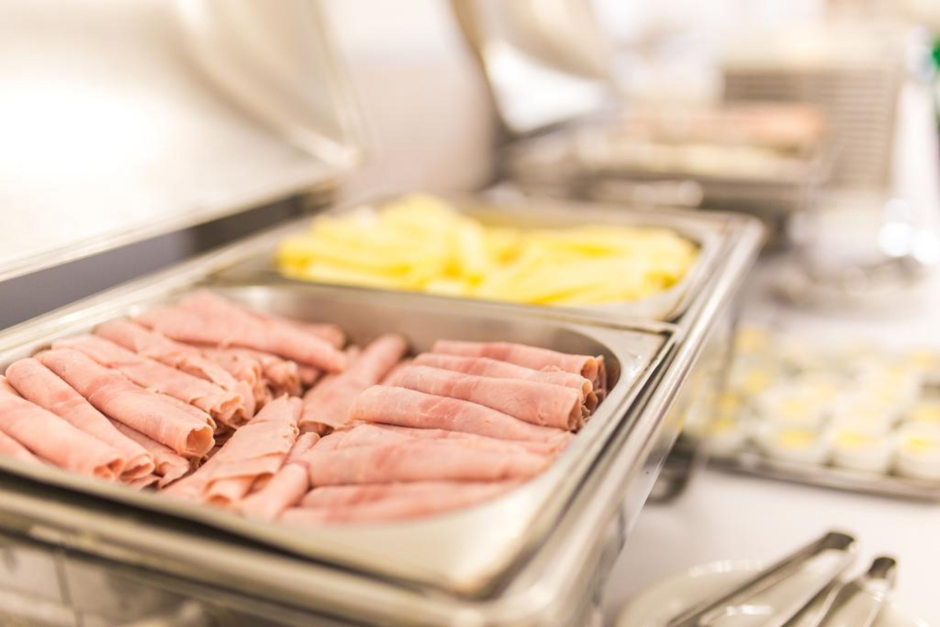 Buffet com presunto fatiado e abacaxi.