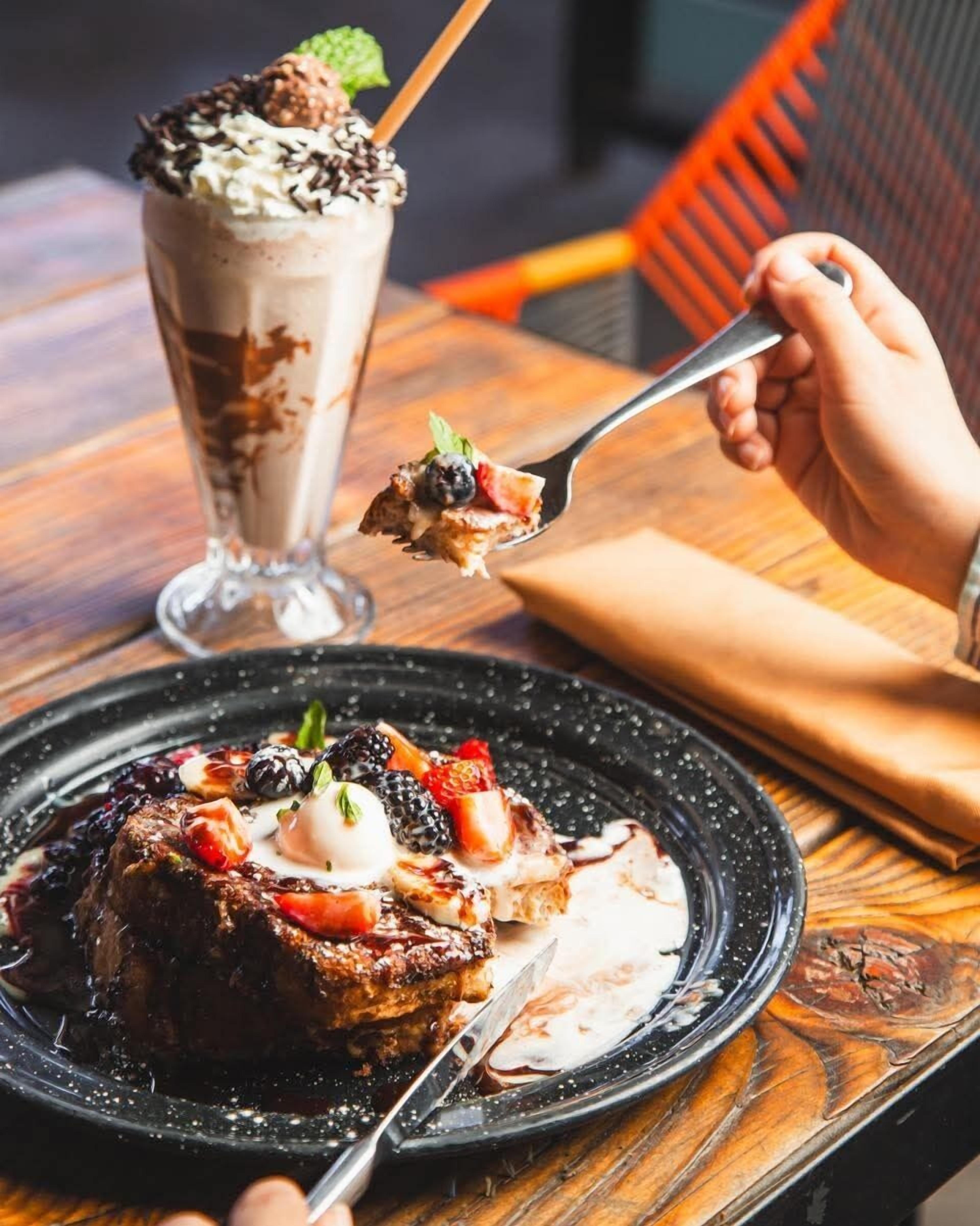A dessert with a scoop of ice cream and a piece of cake on a plate.