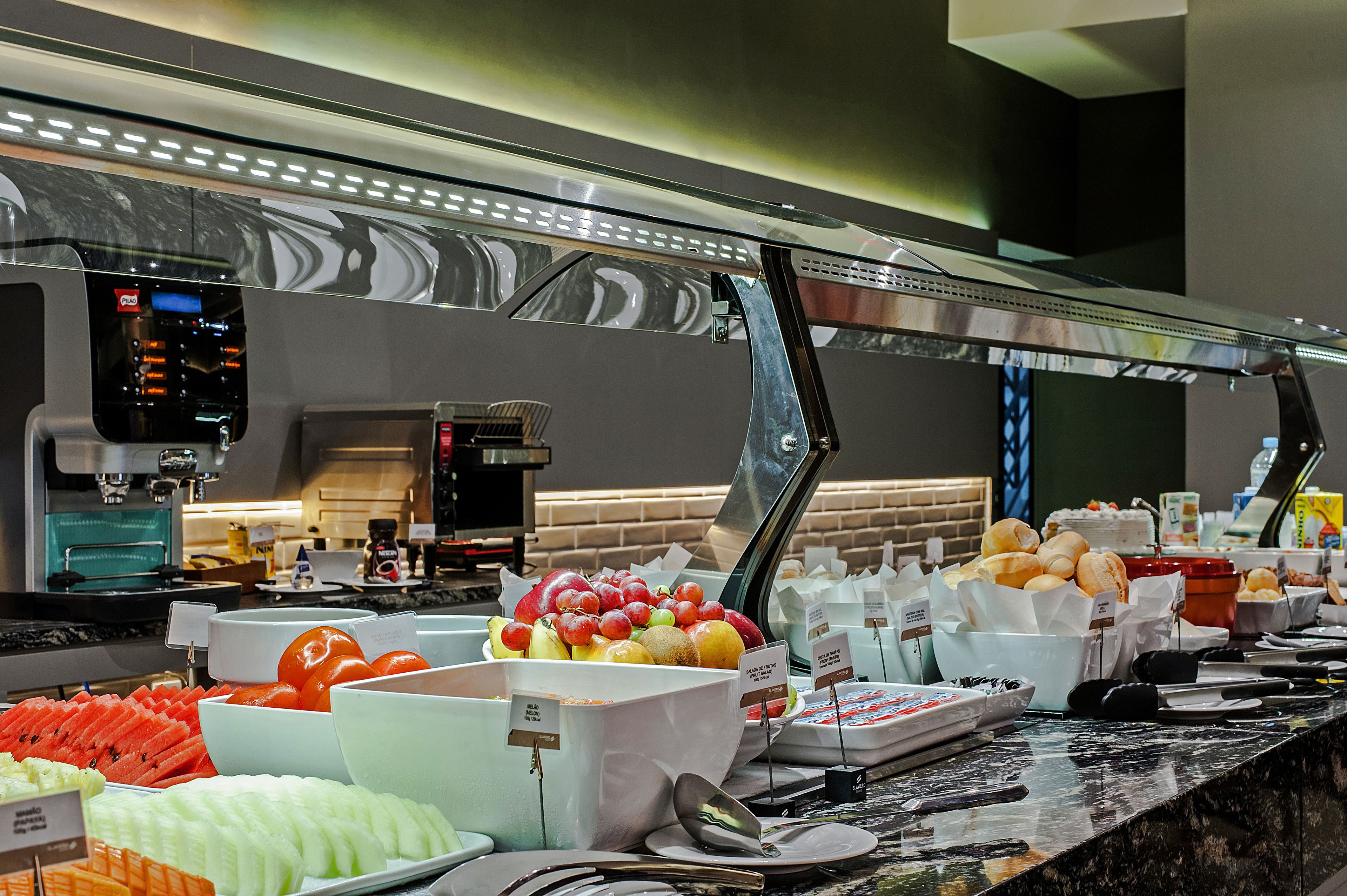 A buffet with various food items and a coffee machine.
