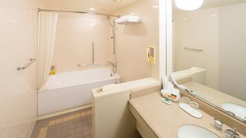 A modern bathroom with a bathtub, a shower, a sink, and a large mirror.