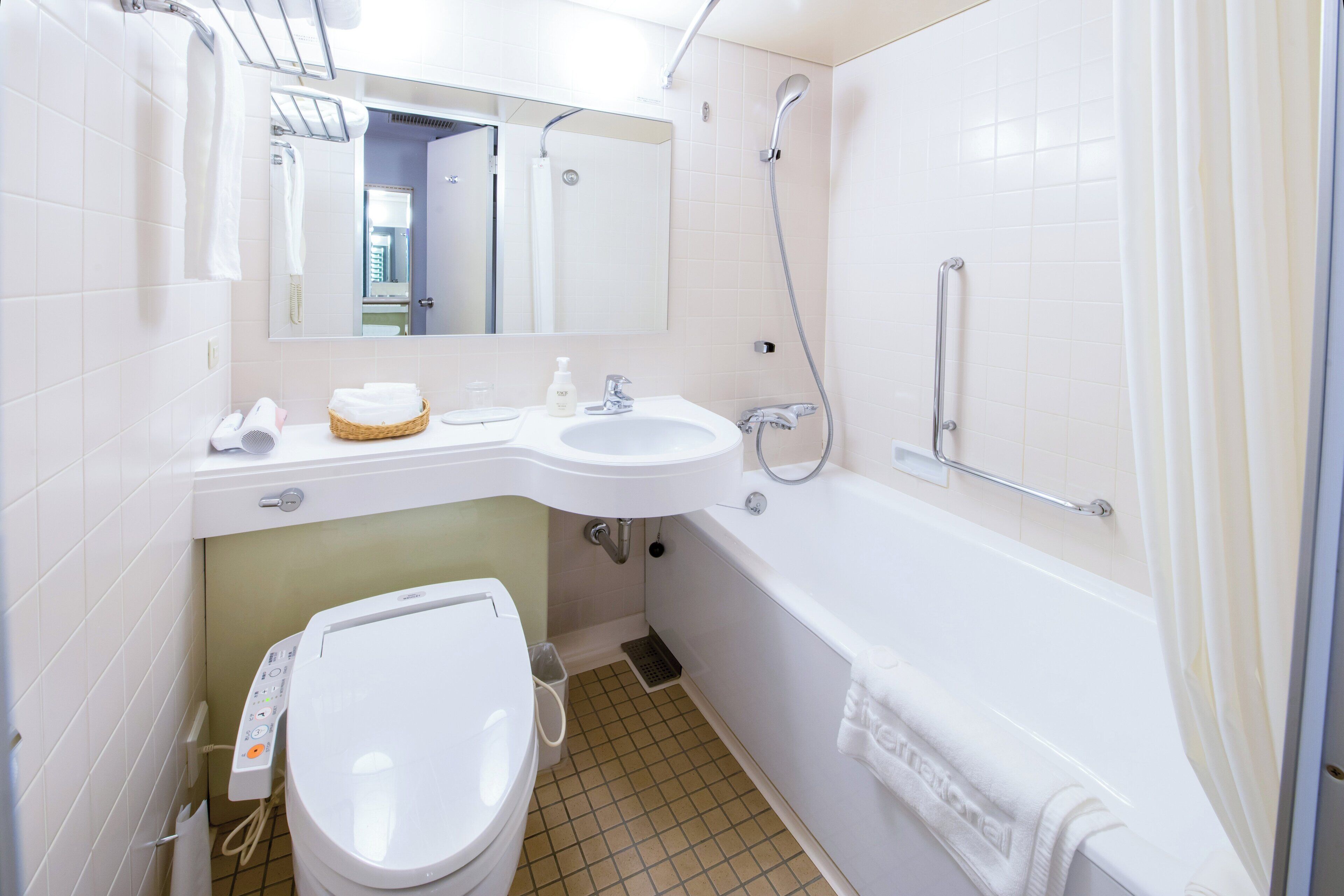 combined shower/bathtub, free toiletries, hair dryer, slippers