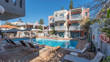 Outdoor pool, open 9:00 AM to 6 PM, pool umbrellas, pool loungers