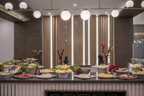 A buffet setup with various food items and decorative elements. - L'Oceanica Beach Resort Hotel - All Inclusive (Kemer)