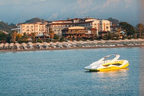 A water jet ski on a calm lake with a hotel and beach in the background. - L'Oceanica Beach Resort Hotel - All Inclusive (Kemer)