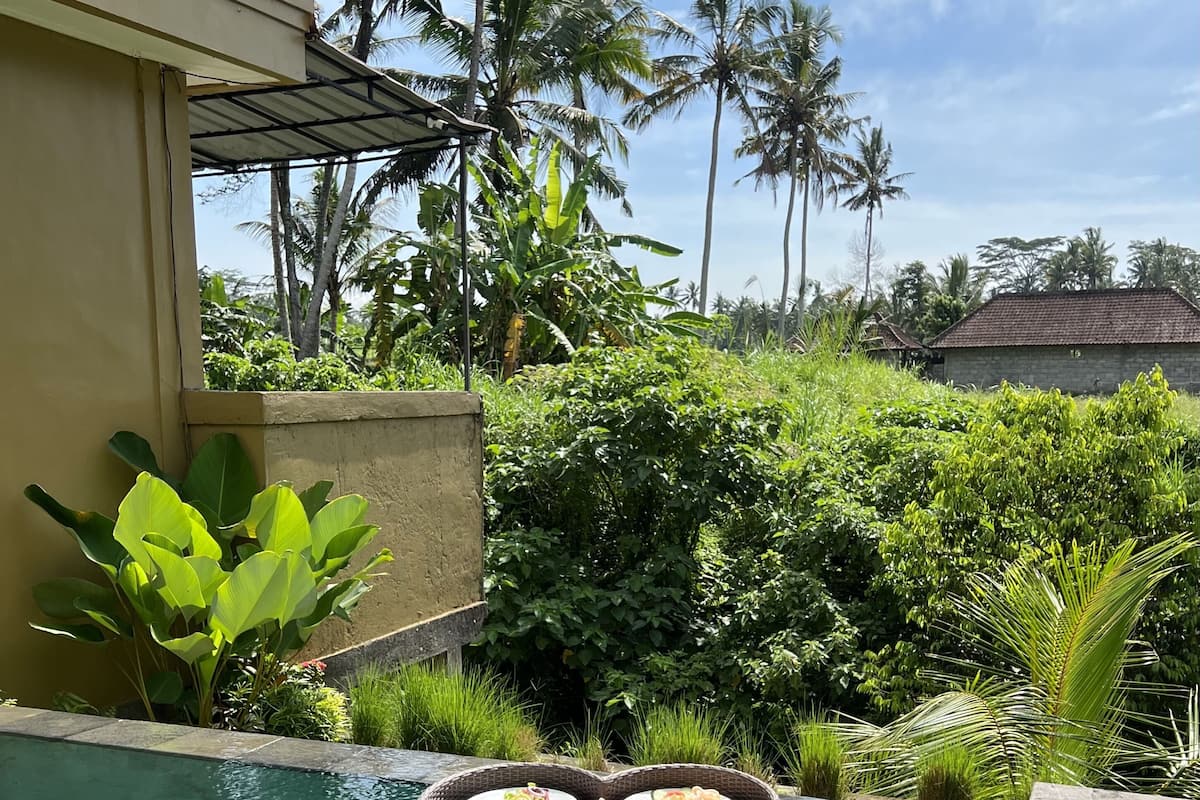 A poolside area with a floating tray of breakfast items.