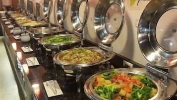 A buffet line with various dishes in metal serving containers.