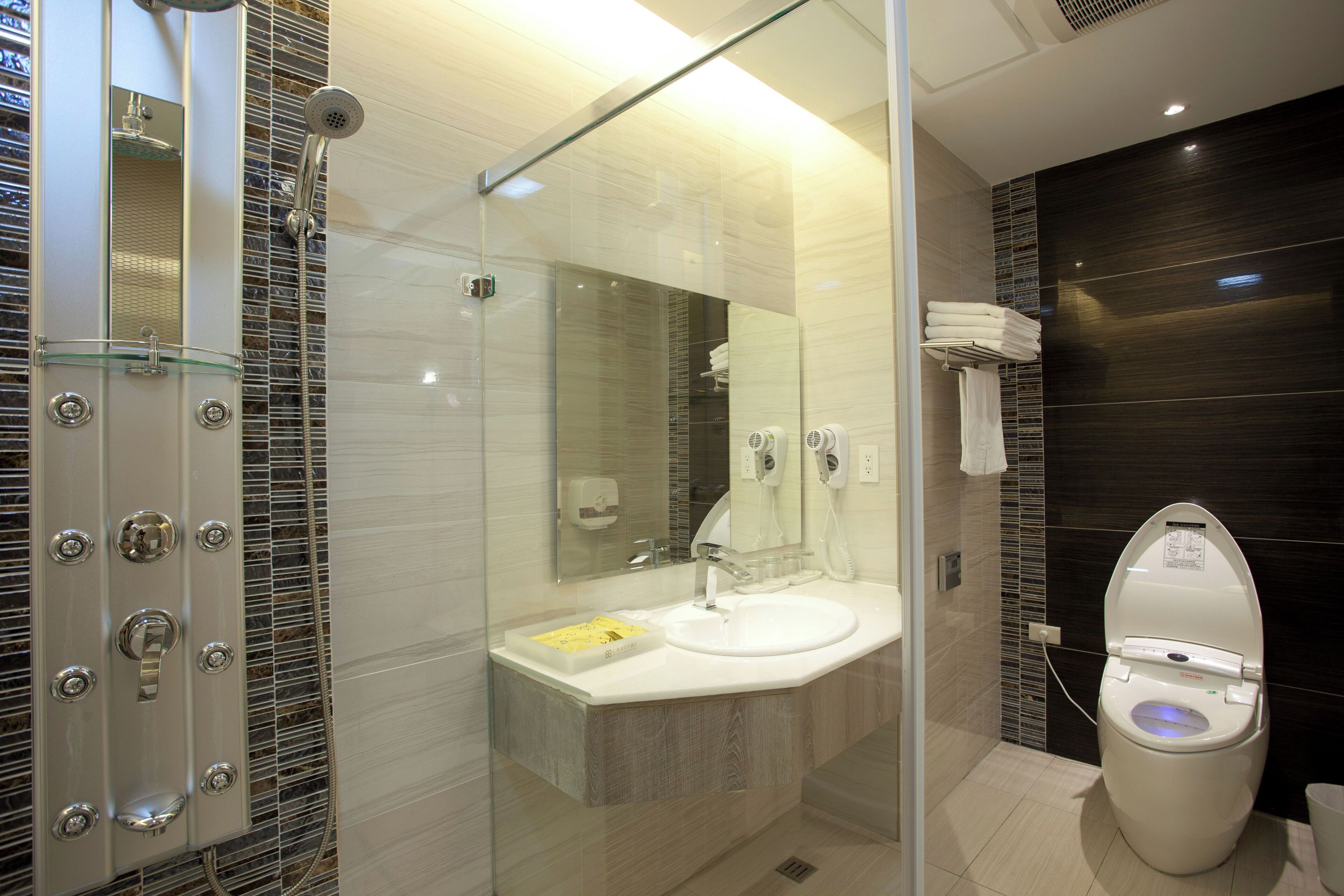 lake view deluxe quadruple room | bathroom | hair dryer, slippers, towels, soap