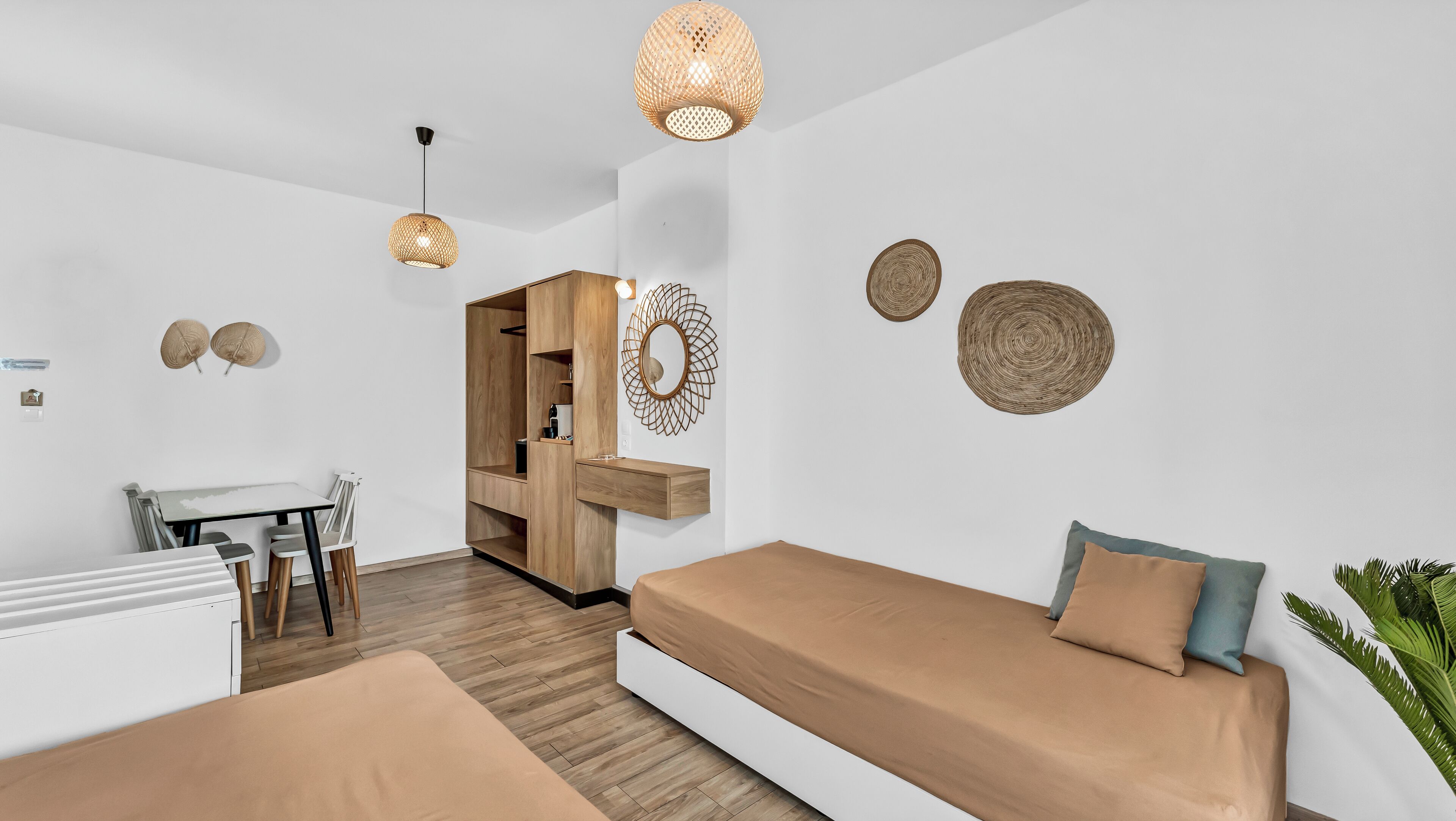 A modern, minimalist room with a bed, a desk, and a wardrobe.