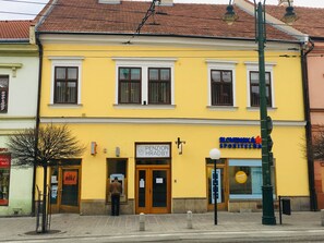 A yellow building with a sign for 'PENZION HRADBY'. - Penzión Hradby (Prešov)