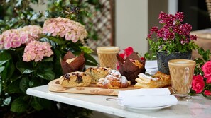 A table with pastries, a coffee cup, and a potted plant. - The Ashe Hotel (Tralee)
