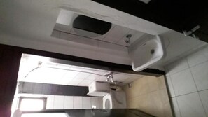 A bathroom with a white sink, a toilet, and a shower area. - Aydın Otel Pansiyon (Antalya)