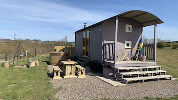 Cozy cottage with a porch, garden, and play area.