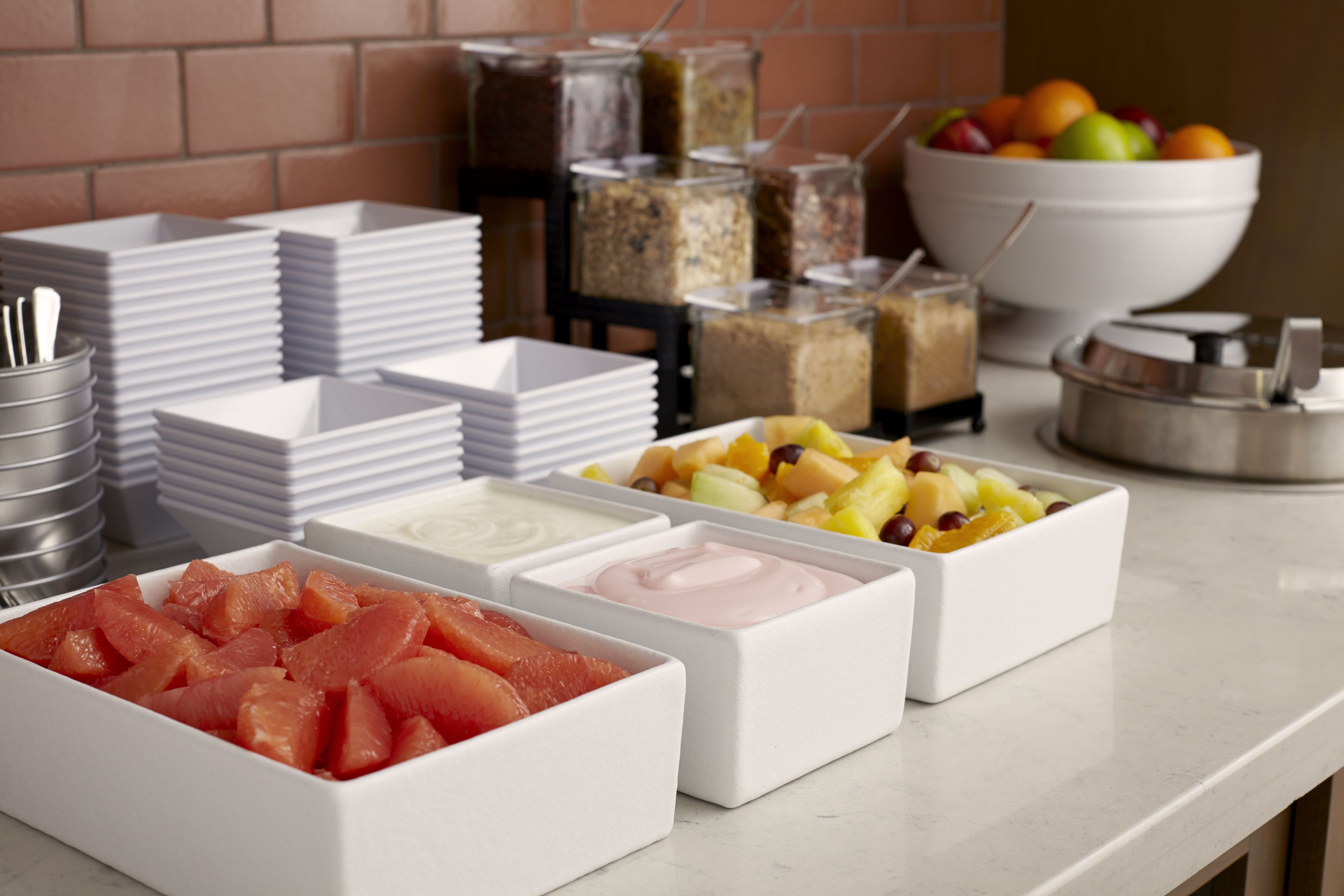 A buffet setup with various food items and containers.