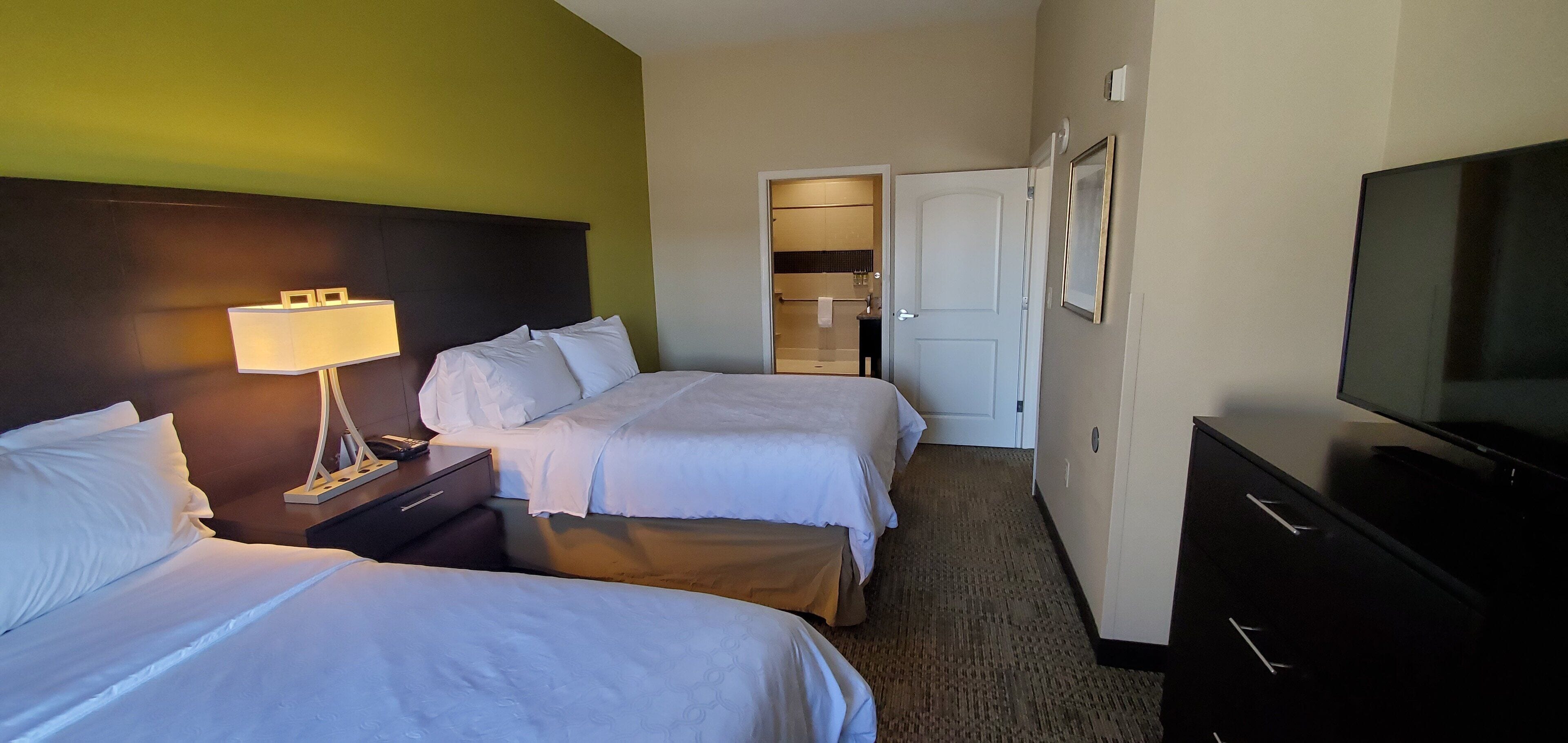 Premium bedding, desk, laptop workspace, blackout curtains