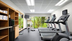 A gym with treadmills, dumbbells, and a water dispenser. - Towneplace Suites Columbia Northwest/Harbison (Columbia)