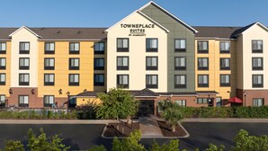 A hotel with multiple floors, a prominent sign reading "Towneplace Suites by Marriott," and a landscaped entrance area. - Towneplace Suites Columbia Northwest/Harbison (Columbia)