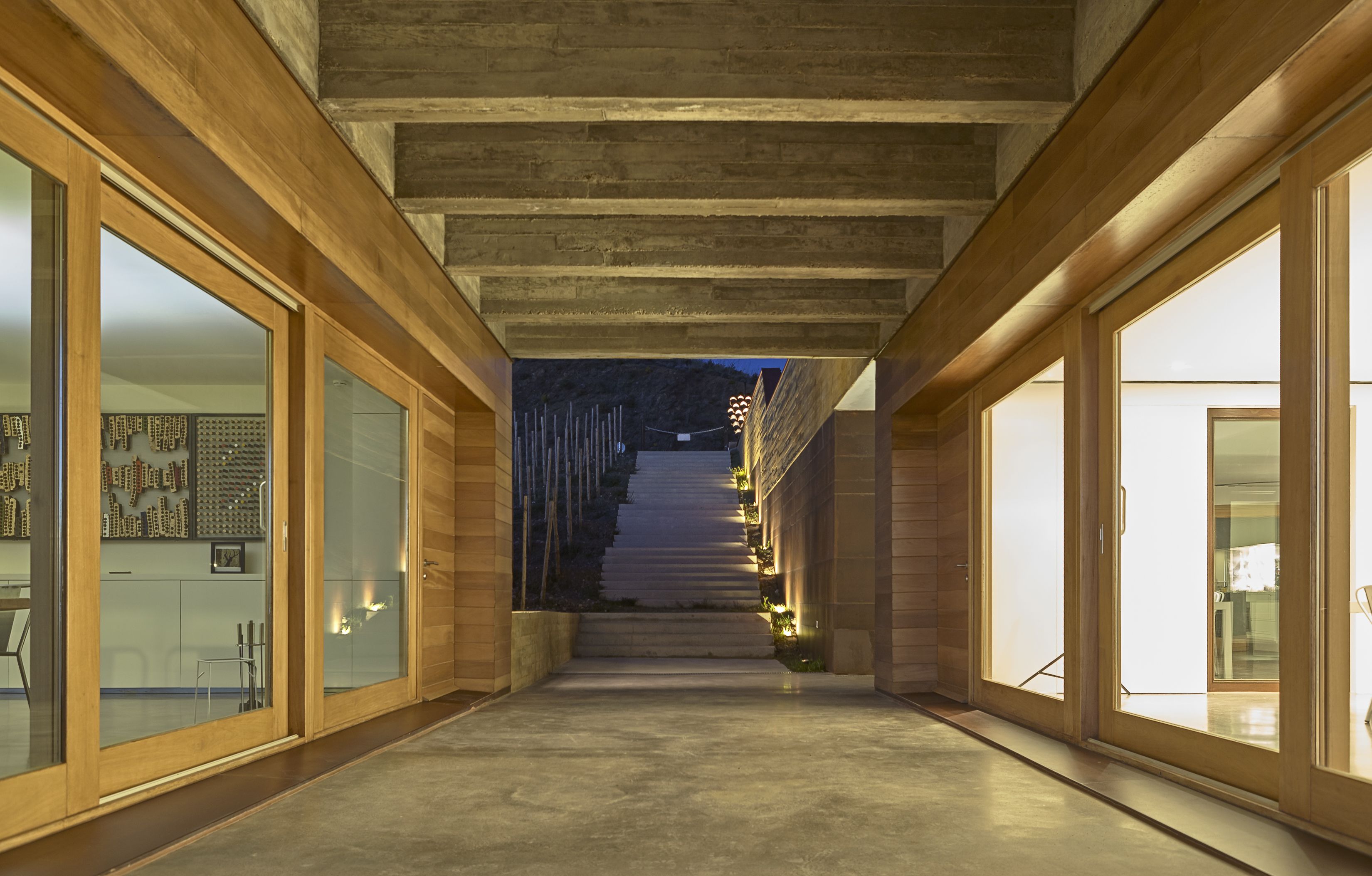 A modern interior with a concrete staircase leading to a higher level.