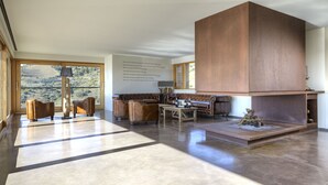 A spacious living room with a large wooden cabinet, leather sofas, and a coffee table. - Trossos del Priorat (Gratallops)