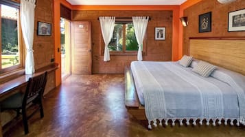 Um quarto com uma cama, uma escrivaninha e uma janela com cortinas.