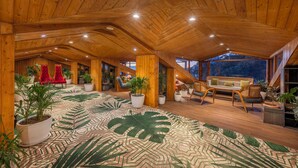 A spacious room with a high wooden ceiling, large windows, and a patterned floor. - Snow Valley Resorts (Shimla)