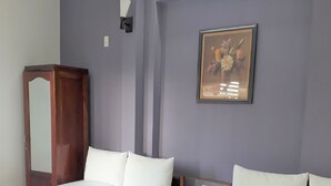 A bedroom with a bed, a dresser, and a framed picture on the wall. - Blue Sea 2 Hotel (Bac Nha Trang)