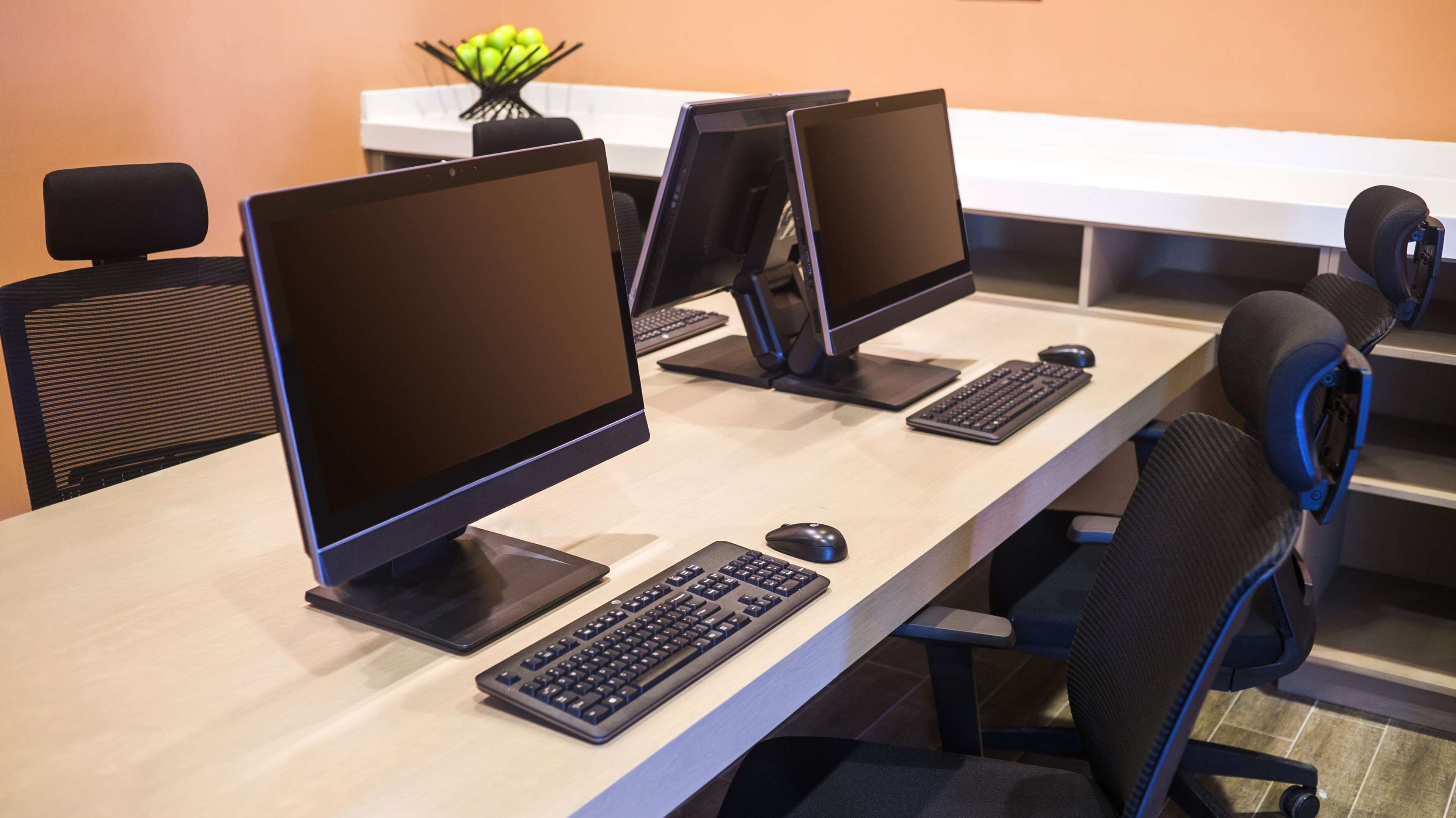 A computer lab with multiple workstations, each equipped with a monitor, keyboard, and mouse.