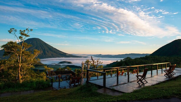 A wooden deck with chairs overlooking a mountainous landscape and a valley. - The Westin Rusutsu Resort (Rusutsu)